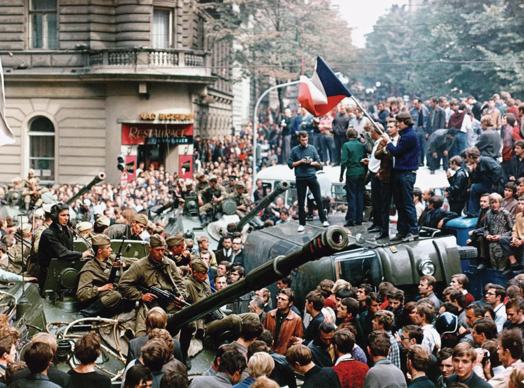 a crowd standing on tanks